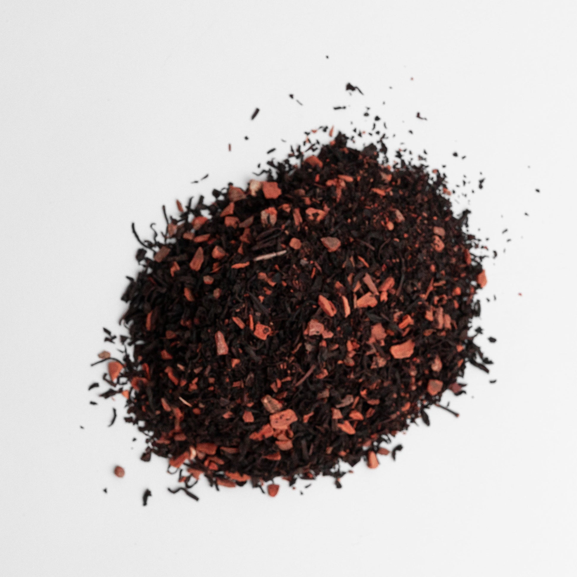 Dried black tea leaves on a white background cinnamon and vanilla