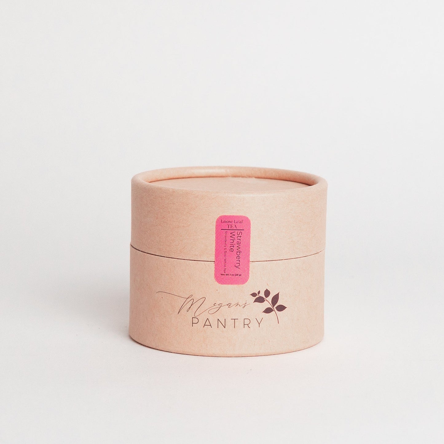 Small beige container with a pink label on a light gray background